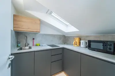 a kitchen with a sink and a microwave at Mias Apartments - #MiasEppan#Badl in Appiano sulla Strada del Vino