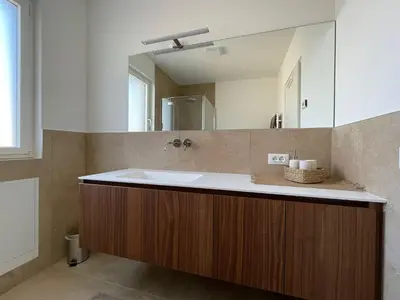 a bathroom with a sink and a mirror at Apartments Johanna in Nalles
