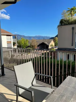 a white chair and a table on a deck at Apartments Johanna in Nalles