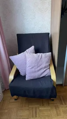 a blue chair with two pillows on top of it at Living Apartment Larcher in Verano