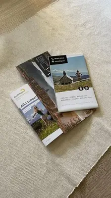 two magazines sitting on top of a table at Living Apartment Larcher in Verano