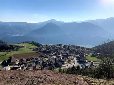 a small town on a hill with mountains in the background at Living Apartment Larcher in Verano