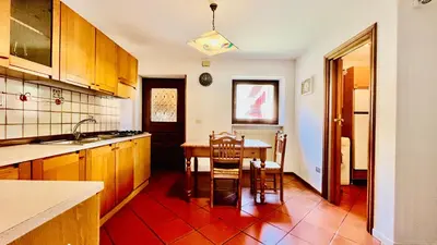 a kitchen with a table and chairs in it at PredazzoHouse in Predazzo