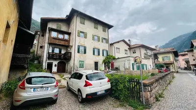 two cars parked in front of a building at PredazzoHouse in Predazzo