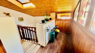 a small kitchen with a refrigerator in a room at PredazzoHouse in Predazzo