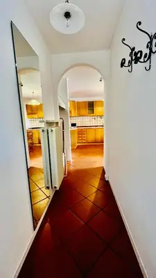 a hallway of a house with a red tile floor at PredazzoHouse in Predazzo