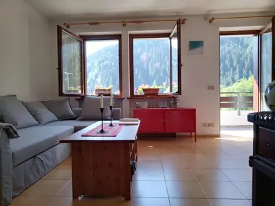 a living room with a couch and a table at Casa FALCADE DOLOMITI in Canale dʼAgordo