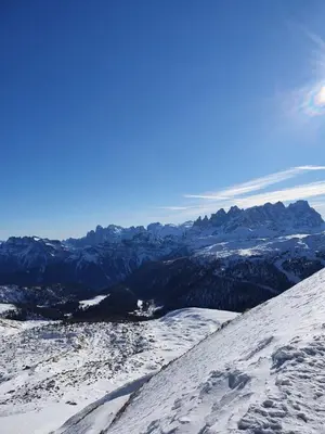 a view of a snowy mountain with mountains in the background at Casa FALCADE DOLOMITI in Canale dʼAgordo