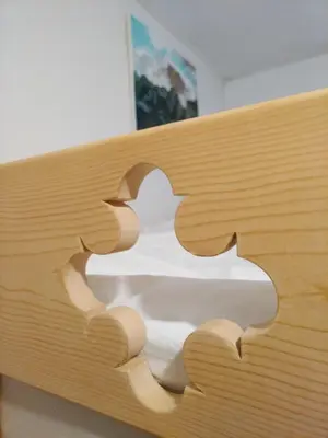 a wooden bed with a jigsaw puzzle on it at Casa FALCADE DOLOMITI in Canale dʼAgordo