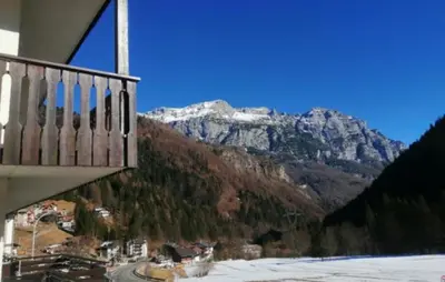 a view of a snow covered mountain from a balcony at Casa FALCADE DOLOMITI in Canale dʼAgordo