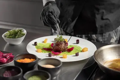 a person is preparing a dish on a table at Luxury Chalet Vilaiet in Ortisei