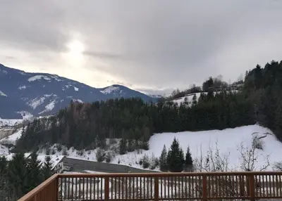 a view of a snow covered valley with mountains at Appartamento Flora in Tesero