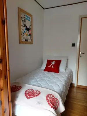 a bedroom with a bed with two hearts on it at APPARTAMENTO CORTINA 1956 in Cortina dʼAmpezzo