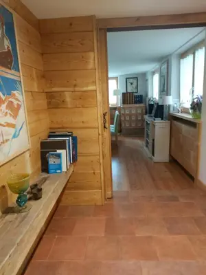 a room with a wooden walls and a kitchen at APPARTAMENTO CORTINA 1956 in Cortina dʼAmpezzo