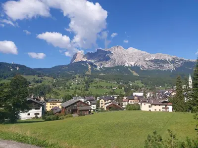 a town in a valley with a mountain in the background at APPARTAMENTO CORTINA 1956 in Cortina dʼAmpezzo