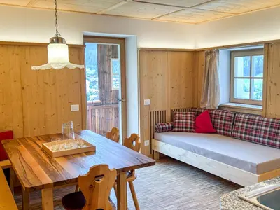 a living room with a couch and a table at Appartements ai Sanc in Corvara in Badia