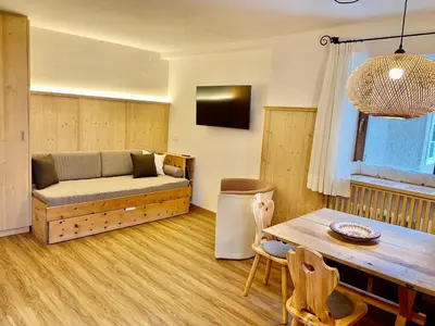 a living room with a couch and a table at Appartements ai Sanc in Corvara in Badia