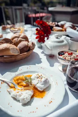 a table with a plate of food on it at Hotel Rose Wenzer in Vols am Schlern