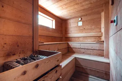 an inside of a wooden cabin with a sauna at Hotel Rose Wenzer in Vols am Schlern