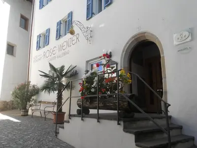 a building with a staircase with a christmas tree on it at Hotel Rose Wenzer in Vols am Schlern