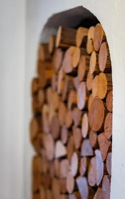 a pile of wooden hearts on a wall at DolomiApartments - Casa Margherita in Predazzo