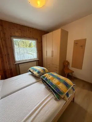 a bedroom with a bed with two pillows and a window at Appartamento Scacciapensieri in Meida