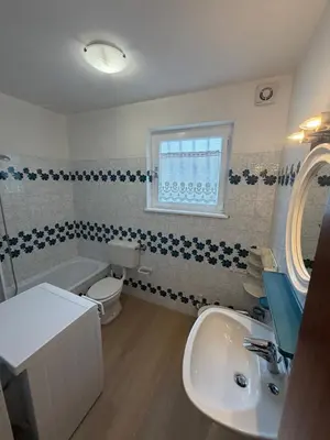 a bathroom with a white toilet and a sink at Appartamento Scacciapensieri in Meida