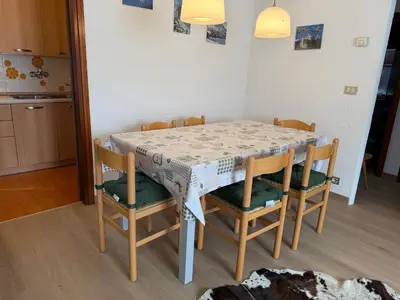 a dining room table with four chairs and a table at Appartamento Scacciapensieri in Meida