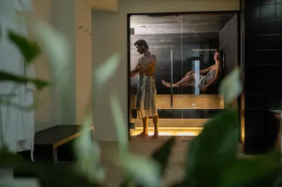 a man standing in front of a mirror with a woman at Wellness Smart Suites in Bolzano