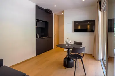 a kitchen and dining room with a table and chairs at Wellness Smart Suites in Bolzano
