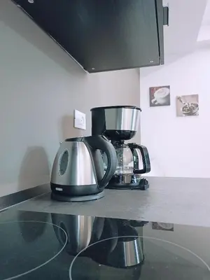 a kitchen counter with a coffee maker and a mixer at Apartment Teatro in Bolzano