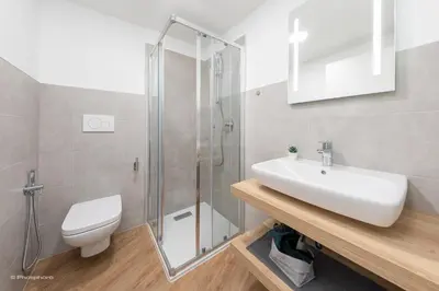 a bathroom with a toilet and a sink and a shower at Apartment Teatro in Bolzano