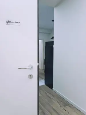 a door in a room with white walls and wood floors at Apartment Teatro in Bolzano