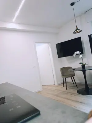 a living room with a table and a chair at Apartment Teatro in Bolzano