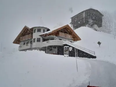 a building covered in snow in a snow storm at Appartamento l’ Aier - Arabba - Dolomiti in Livinallongo del Col di Lana