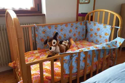 a bedroom with a bed with red roses on it at App. Valentina in Segonzano