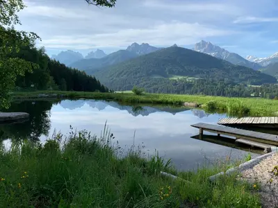 a view of a lake with mountains in the background at Mittersteinerhof in Villabassa