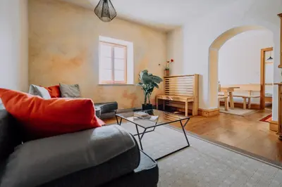 a living room with a couch and a table at Mittersteinerhof in Villabassa