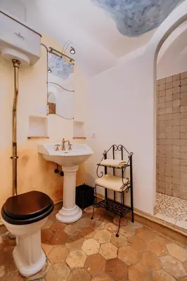 a bathroom with a toilet and a sink at Mittersteinerhof in Villabassa