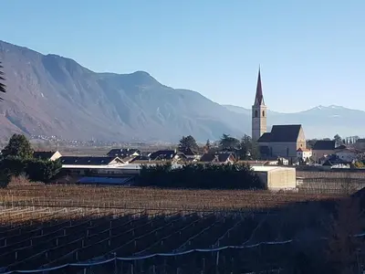 a small town with a church and a church steeple at Birkhof in Lana