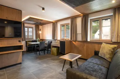a living room with a couch and a table at Adlhof Apartments in Brunico