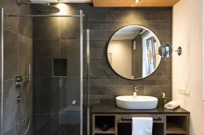 a bathroom with a sink and a mirror at Adlhof Apartments in Brunico