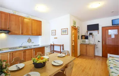 a kitchen with a table with a bowl of fruit on it at Amazing Apartment In Località Carbonin in Carbonin