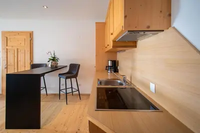 a kitchen with a sink and a counter top at Apartment AEREUS Krumas-Living - Kronplatz in San Lorenzo di Sebato