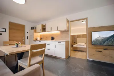 a kitchen with a table and a dining room at Living Miramor in Racines