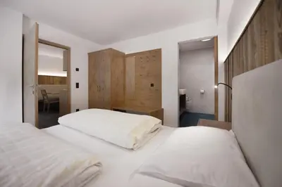 a bedroom with two white beds and a desk at Living Miramor in Racines