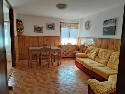 a living room with a couch and a table at Appartamento La Casa di Violetta in Tonadico