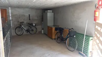 two bikes are parked in a garage at Appartamento La Casa di Violetta in Tonadico