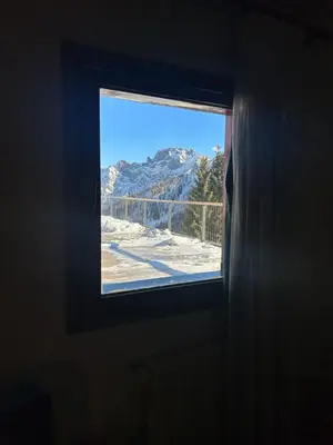 a window in a room with a view of a mountain at Perla Dolomiti Falt in Falcade