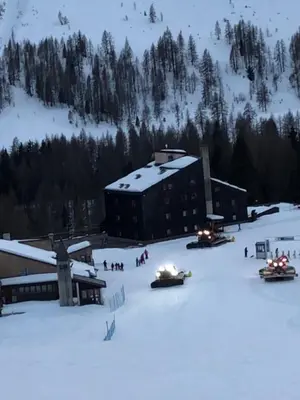 a building in the snow in front of a ski resort at Perla Dolomiti Falt in Falcade